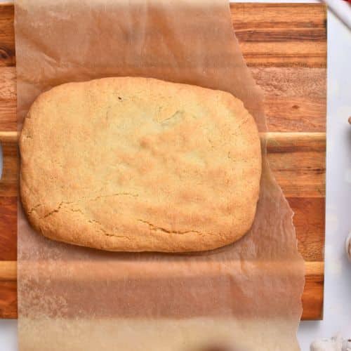 Pre-cooked Almond Flour Biscotti log on a chopping board.