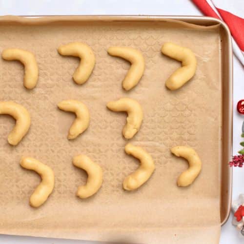 Formed Almond Horns Cookies on a baking sheet.