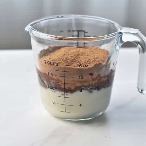 Wet Banana Chocolate Muffin ingredients in a jug.