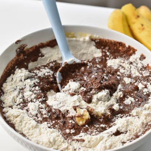 Combining Banana Chocolate Muffin batter in a bowl.