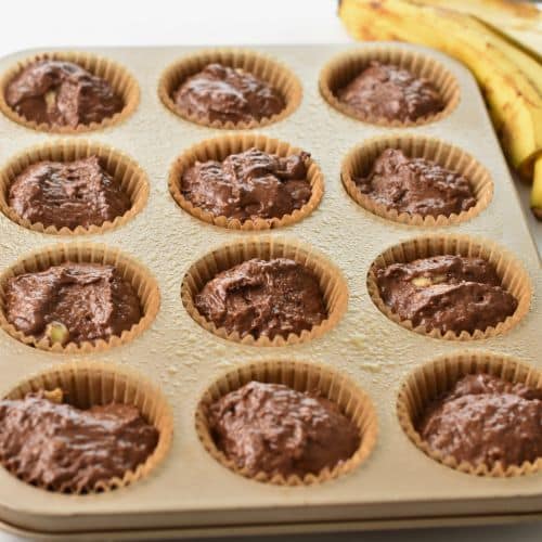 Banana Chocolate Muffins ready to bake in a muffin tin.