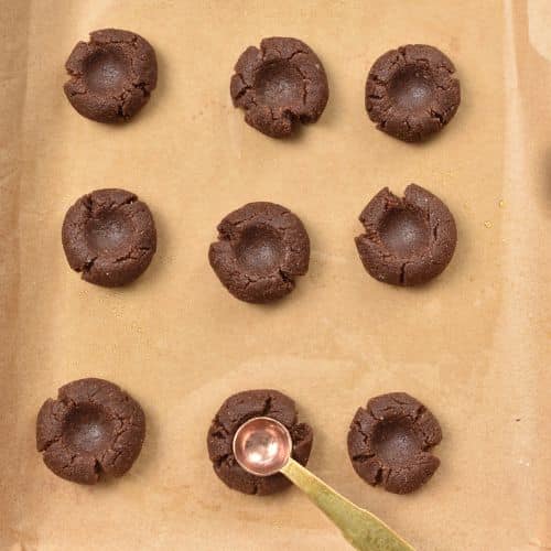 Forming the thumbprint on Chocolate Almond Thumbprint Cookies