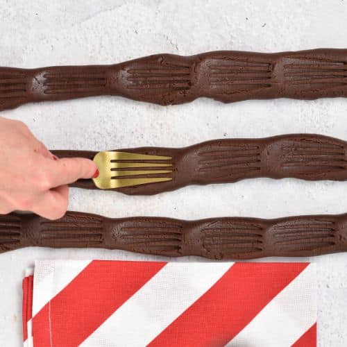 Forming shortbread cookie strips with a fork.