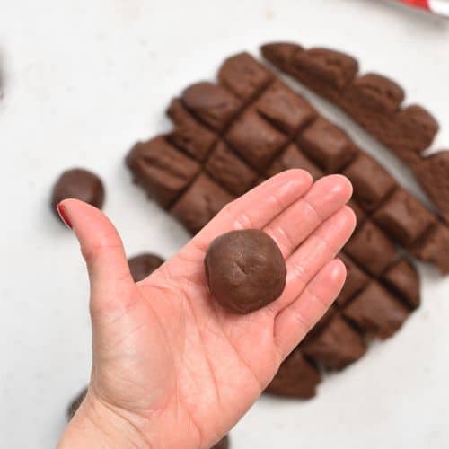 Rolling Chocolate Thumbprint Cookie dough balls.