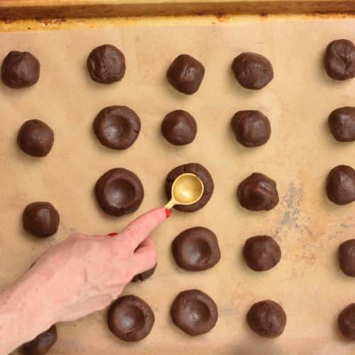 Making the thumbpring on Chocolate Thumbprint Cookies with a spoon.