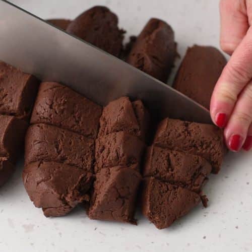 Cutting Chocolate Thumbprint Cookie dough.