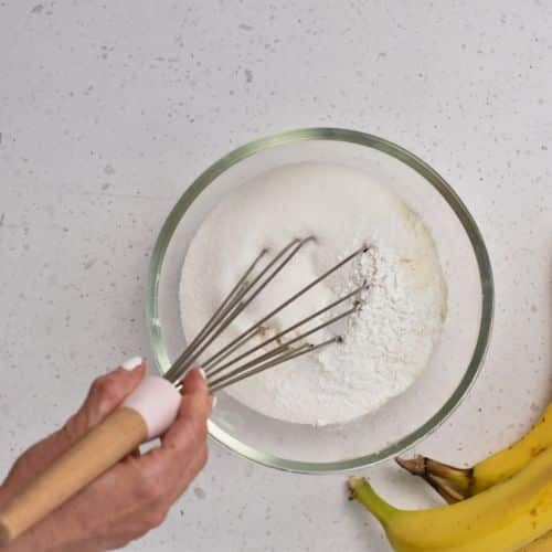 Mixing sugar and cinnamon in a bowl.