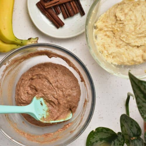 Cinnamon Banana Bread batter split into two bowls with one bowl combined with cinnamon mixture.