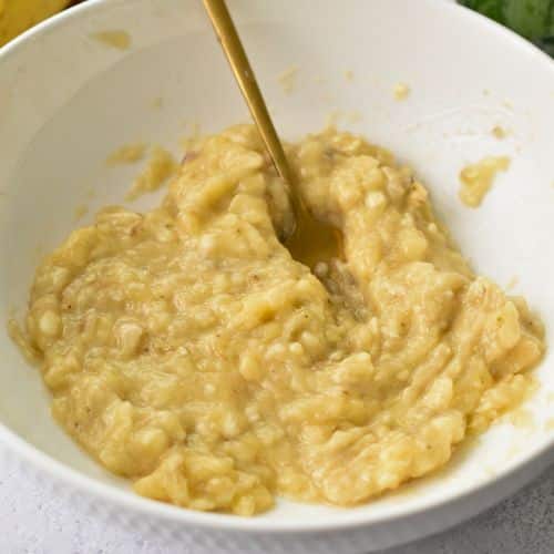 Mashed banana in a mixing bowl.