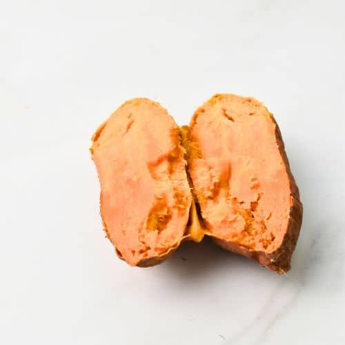 Cooked sweet potato sliced in half.