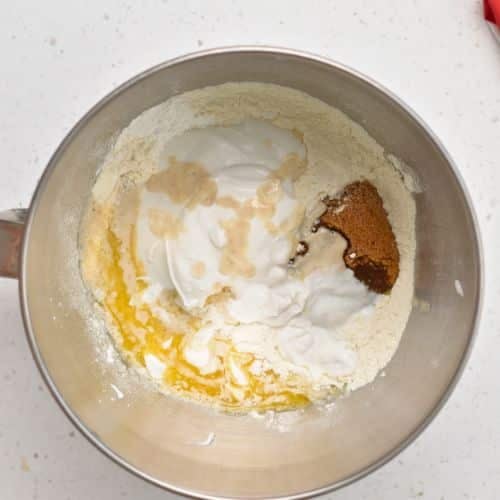 Healthy Cinnamon Roll dough ingredients in the bowl of a stand mixer.