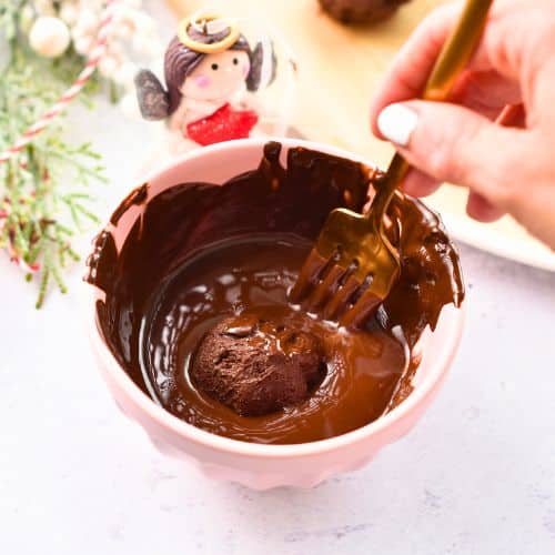 Dipping Healthy Truffles into melted chocolate for coating.