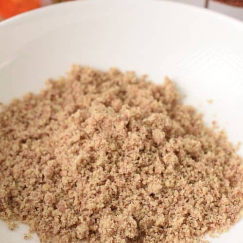 Ground pecans in a mixing bowl.