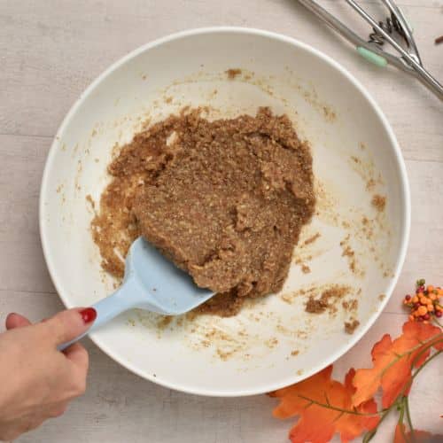 Maple Pecan Cookie dough in a mixing bowl with a silicone spatula.