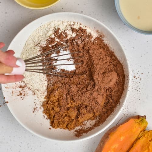 Dry Sweet Potato Chocolate Muffin ingredients in a mixing bowl.