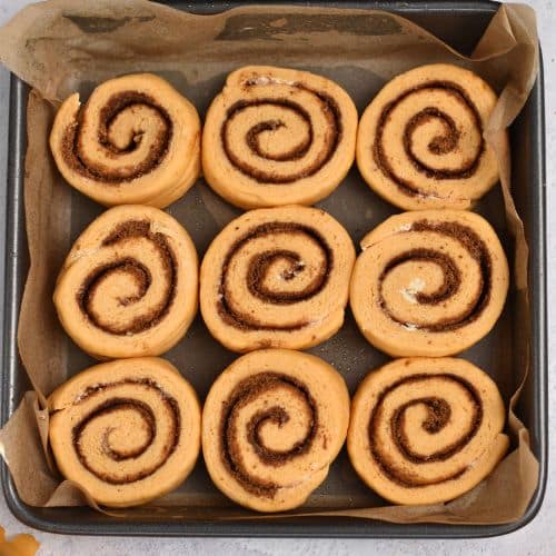 Sweet Potato Cinnamon Rolls ready to bake in a pa.