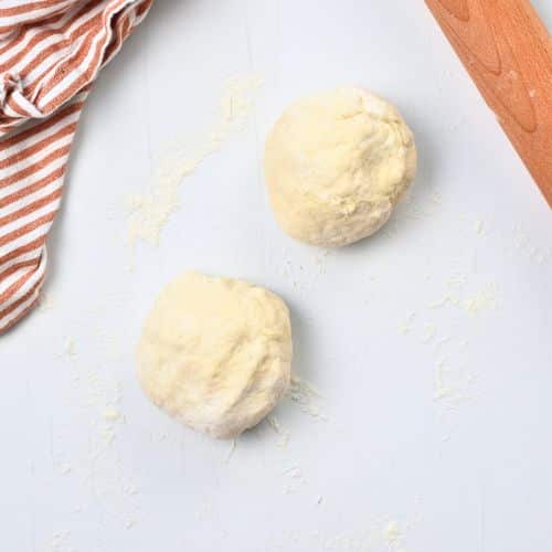 2-Ingredient Pizza Dough rolled into two balls.