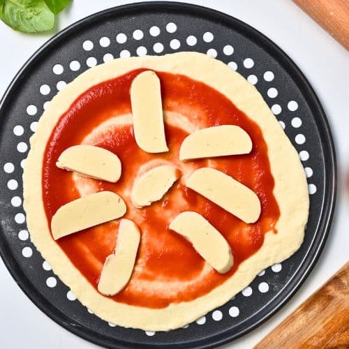 2-Ingredient Pizza Dough loaded with pizza sauce and dairy-free mozzarella.