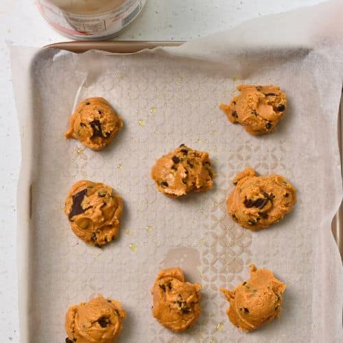 4-Ingredient Peanut Butter Cookie dough balls on a baking sheet.