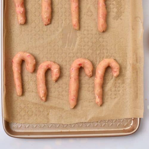 Almond Candy Cane Cookies ready to bake on a cookie sheet.