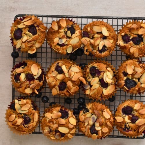 Almond Flour Blueberry Muffins cooling down on a wire rack.