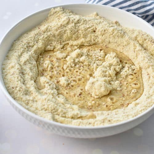 Adding liquids to the Almond Flour Muffin dry ingredients.