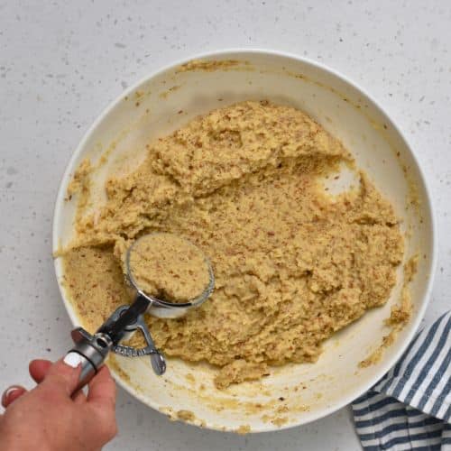 Forming Almond Flour Muffins with an ice cream scoop.