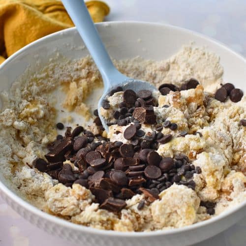 Adding chocolate chips to the Banana Chocolate Chip Cookie batter.