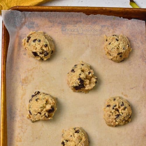 Banana Chocolate Chip Cookie dough balls on a baking sheet.