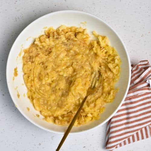 Mashed banana in a mixing bowl.