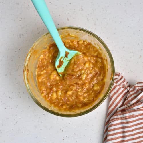 Liquid Biscoff Banana Bread ingredients in a mixing bowl.