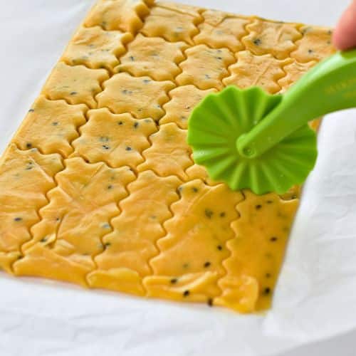 Cutting Chickpea Crackers with a crinkle wheel.