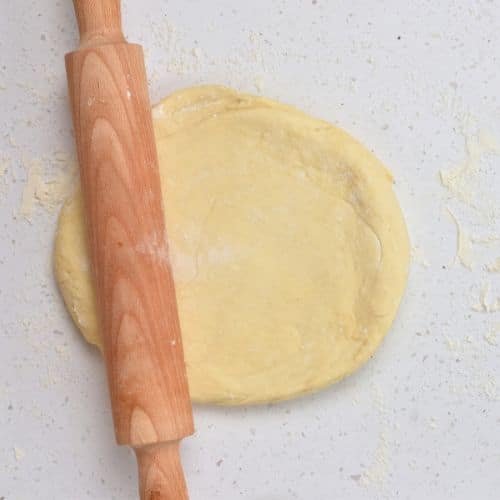 Rolling the Chocolate Cinnamon Roll dough with a rolling pin.