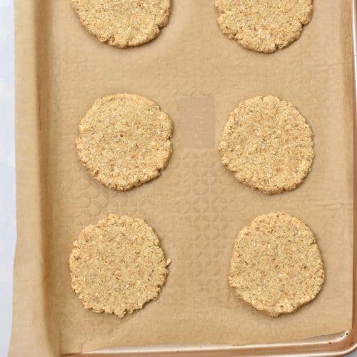 Crispy Oatmeal Cookies ready to bake on a cookie sheet.