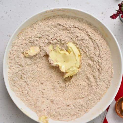 Adding vegan butter to Gingerbread Scones batter.