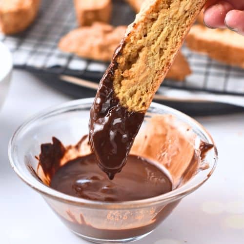 Dipping Healthy Biscotti into melted chocolate.