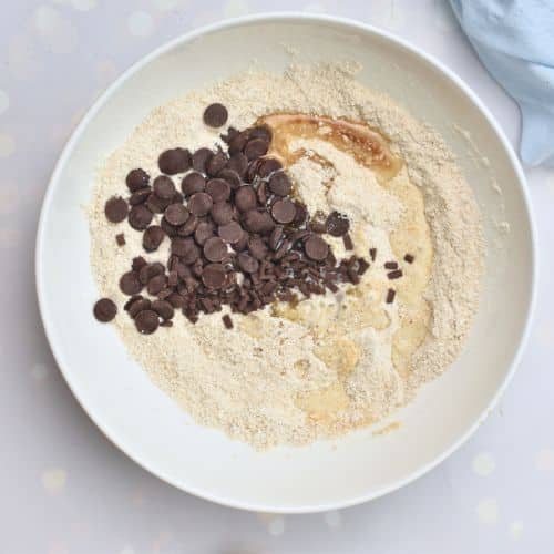 Adding liquid Healthy Chocolate Chip Cookie ingredients and the chocolate chips.