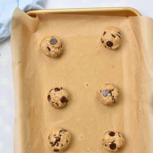 Healthy Chocolate Chip Cookie dough balls on a baking sheet.