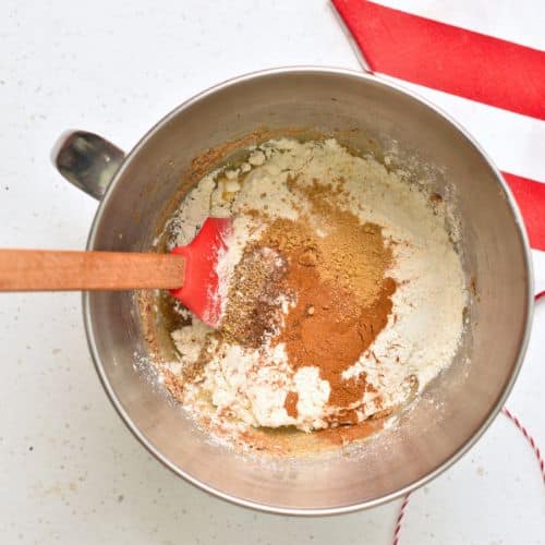 Stirring Healthy Gingerbread Cookie dough in a mixing bowl.