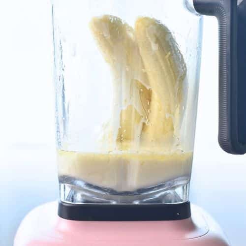 Preparing the banana milk in a blender.