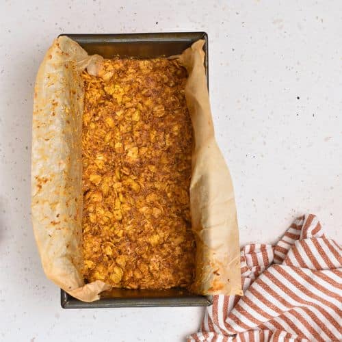 Pressed Peanut Butter Cornflakes Bar base in a loaf pan.