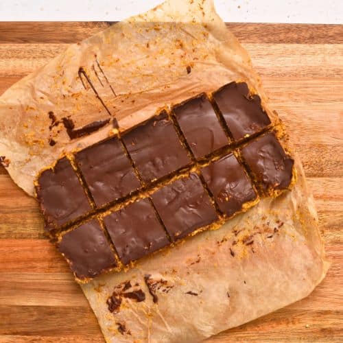 Sliced Peanut Butter Cornflakes Bars on a chopping board.