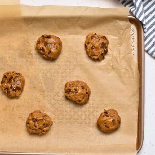 Cookies dough balls on a baking sheet.