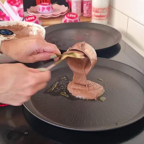 Pouring the Chocolate Pancake batter on the pan.