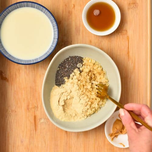 Mixing dry Gluten-Free Porridge ingredients in a bowl.