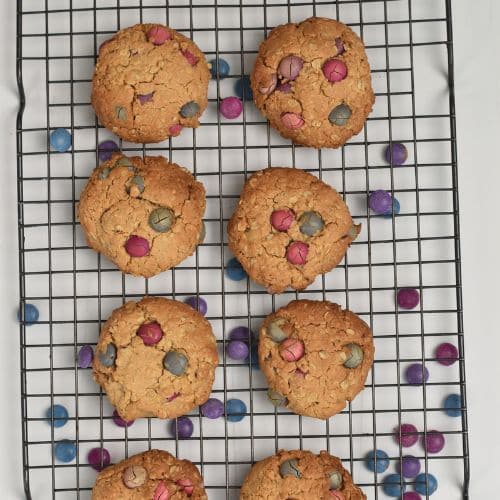 Healthy Monster Cookies cooling on a wire rack.