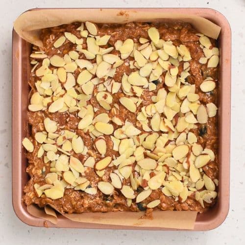 Adding sliced almonds on top of the Healthy Oatmeal Bars.