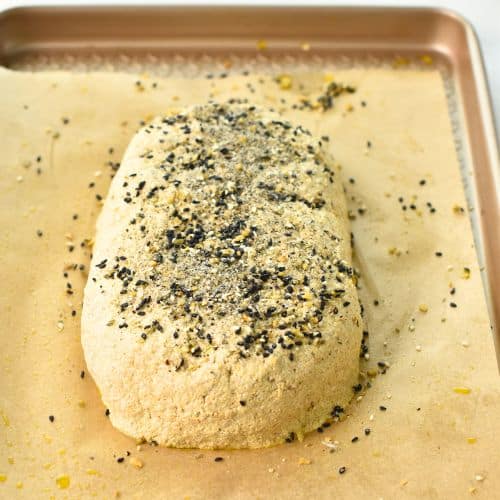 Quinoa Bread on a pan decorated with bagel seasoning.