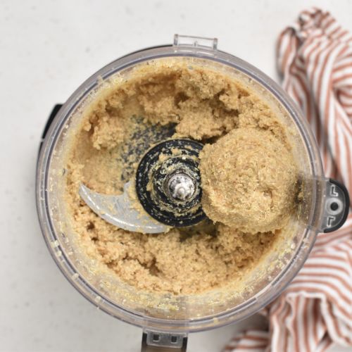 Quinoa Crackers processed in the bowl of a food processor.