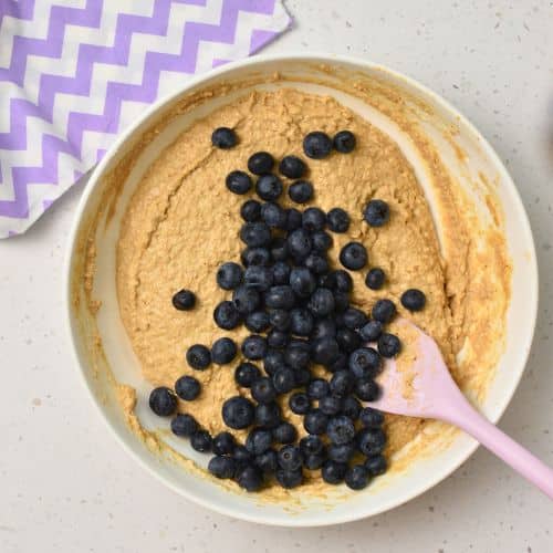 Incorporating blueberries in the Whole Wheat Blueberry Muffin batter,